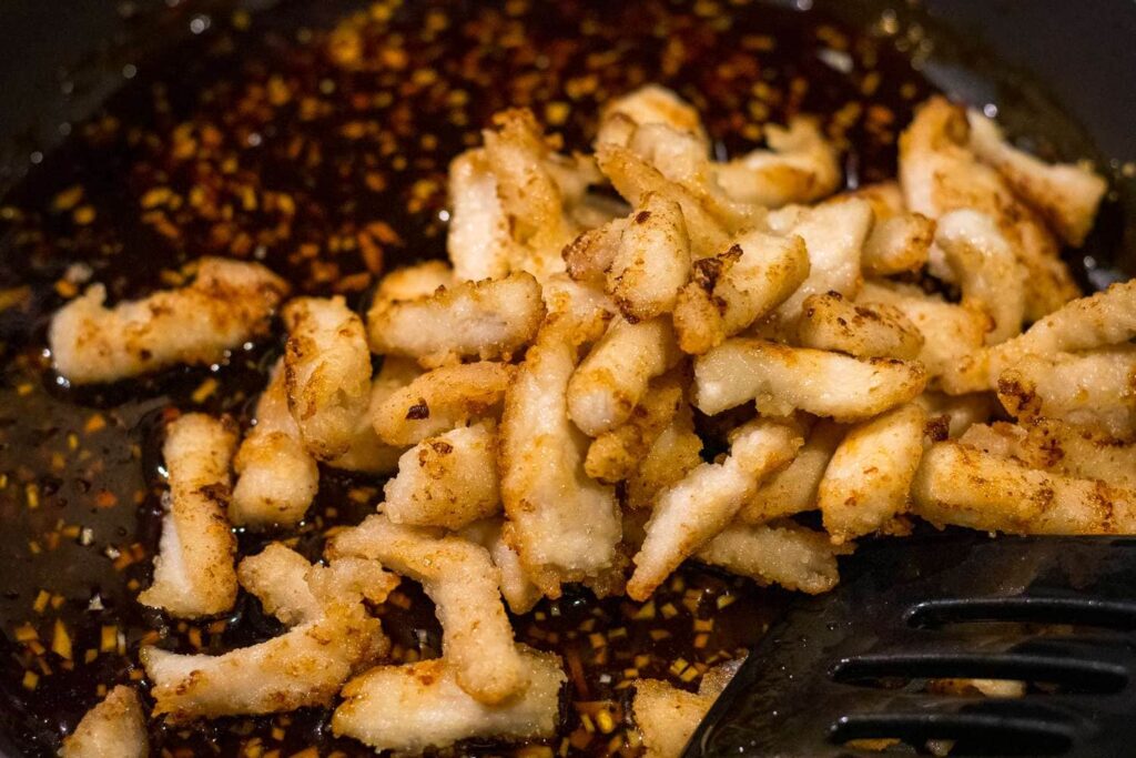 Add the cooked chicken to the sauce and toss until every piece is well coated.
