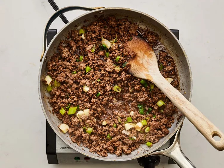 Stir in half of the chopped green onions