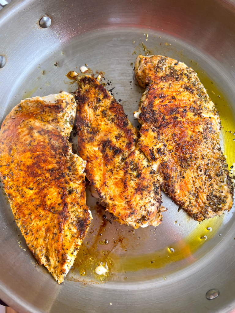 add the avocado oil and place the chicken in the pan