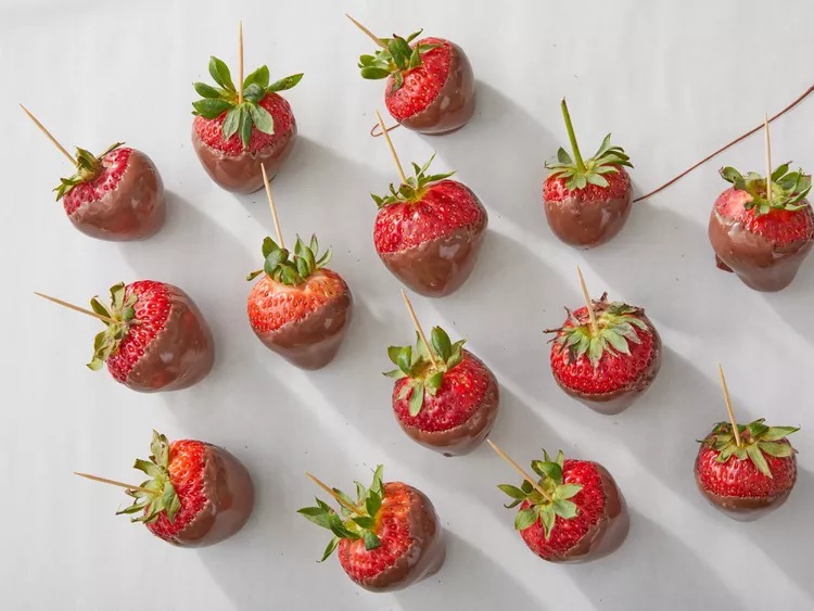 Turn the strawberry upside down and stick the toothpick into a Styrofoam block, or place the dipped strawberry on a sheet of waxed paper. Let the chocolate cool and set completely.