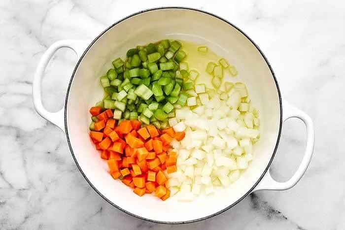 Heat the olive oil in a large pot over medium-high heat. Add the diced onion, carrot, and celery. Cook for about 4 to 5 minutes, until the vegetables begin to soften.