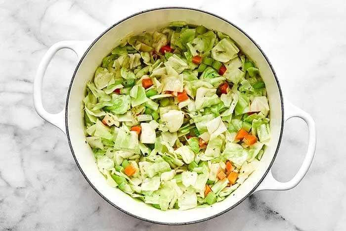 Add the chopped cabbage and stir it in. Let it cook for about 5 minutes, stirring often, so it softens and reduces slightly.