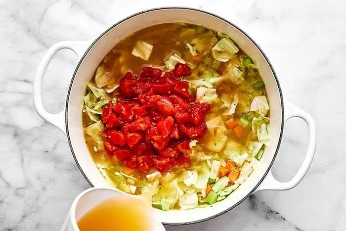 Pour in the diced tomatoes and 4 cups of vegetable broth to start. Bring everything to a gentle simmer and cook uncovered for about 10 minutes, or until the vegetables are as tender as you like. Add more broth if you prefer a thinner soup.