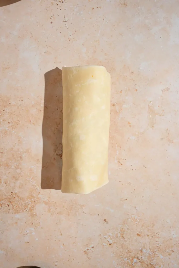 Fold in the sides of the tortilla, then roll it up tightly from the bottom to form a wrap. Repeat with the second tortilla.