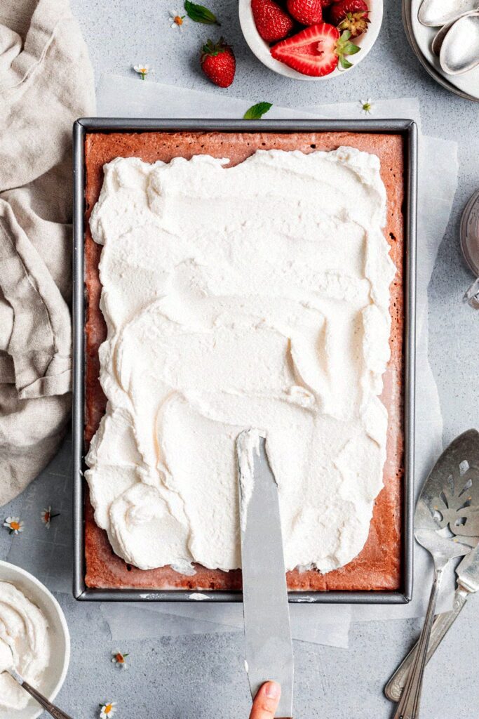 Just before serving, spread the whipped cream evenly over the chilled cake