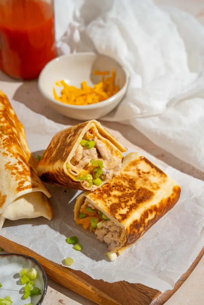 Slice each wrap in half and serve hot.