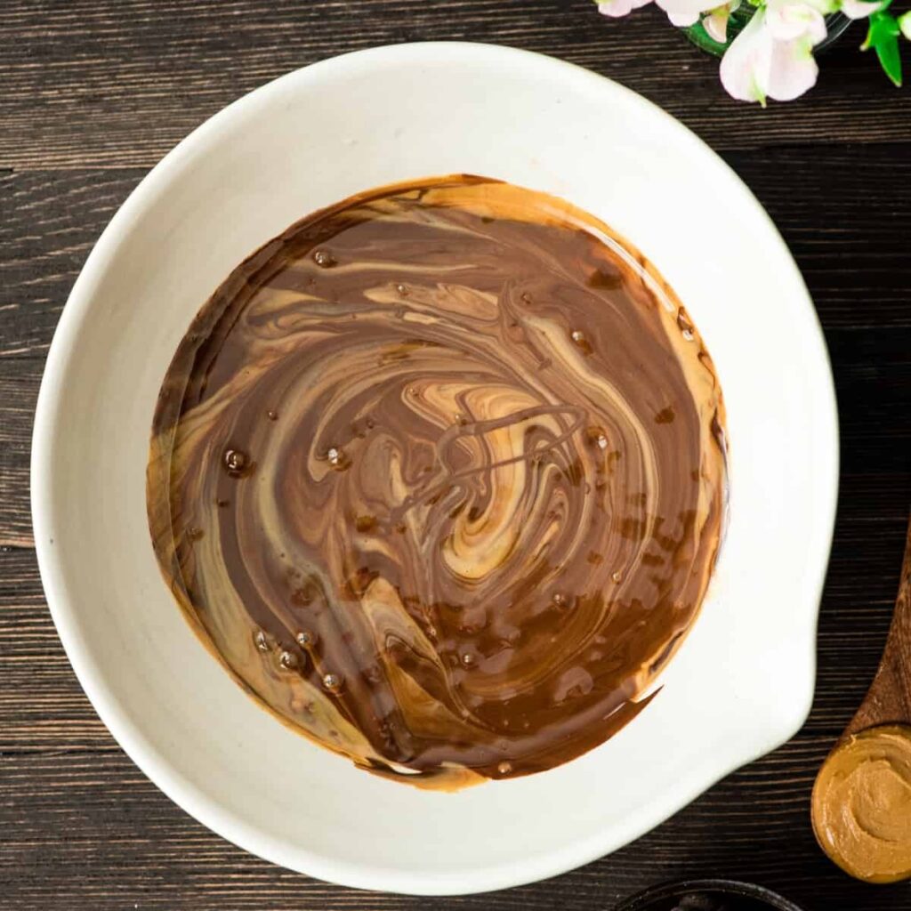Melt the peanut butter and chocolate together. You can do this on the stovetop over low heat or in the microwave in short intervals. Stir until smooth.