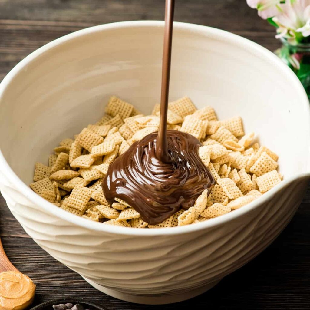 Add the remaining 3 cups of cereal to the bowl. Pour the rest of the chocolate mixture on top.