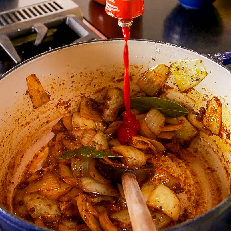 Heat the vegetable oil in a large pan over medium heat. Add the sliced onion and salt. Cook for about 2 to 3 minutes, until softened.