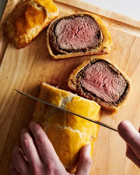 Transfer carefully to a cutting board. Slice into 1-inch pieces with a serrated knife. Sprinkle the meat with flaky salt if desired and serve.