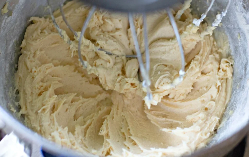 In another bowl, whisk together the flour and baking powder. Add this dry mixture to the wet ingredients and stir until combined. Pour in the milk and mix until the batter is smooth.