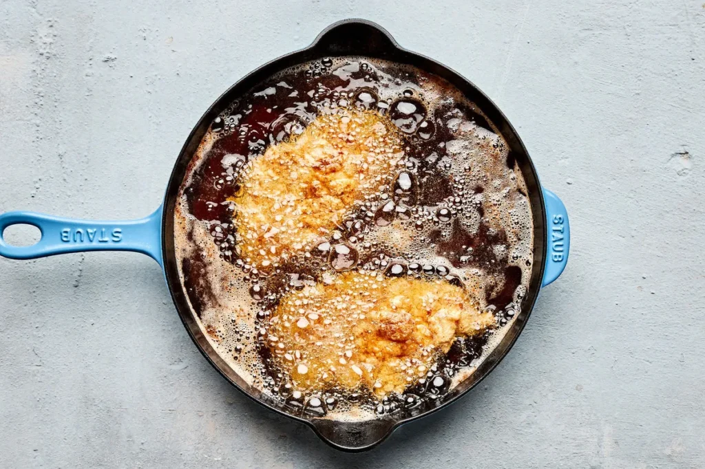 Pour about 1 inch of vegetable oil into a large skillet and heat over medium high heat. Once the oil is hot and shimmering, add two pieces of chicken at a time. Cook for about 3 to 4 minutes per side until golden and cooked through. Transfer the fried chicken to a paper towel lined plate. Repeat with the remaining pieces, adding more oil if needed.