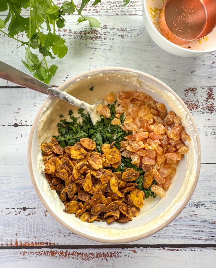 Add the diced apricots, sliced coriander, and the cooled curry toasted almonds. Stir until everything is evenly mixed.