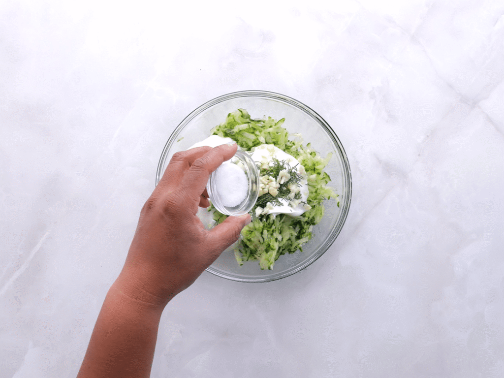 Make the tzatziki sauce. Grate the cucumbers and squeeze out the extra water with a towel. In a bowl, mix the cucumbers with yogurt, dill, garlic, lemon juice, olive oil, salt, and pepper. Stir until smooth and refrigerate until ready to serve.