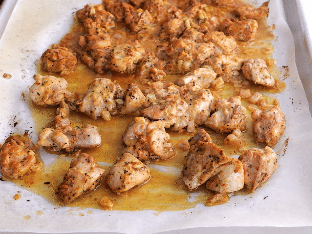 Cook the chicken. Preheat the oven to 400 degrees F. Spread the marinated chicken on a baking sheet and spoon any extra marinade over the top. Bake for 15 to 20 minutes, until the chicken reaches an internal temperature of 165 degrees F. Turn the oven to broil and cook for another 1 to 2 minutes so the edges become lightly crispy.