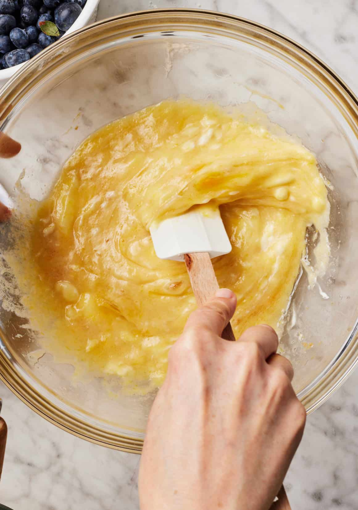 Add the dry ingredients into the wet ingredients and gently stir until just combined. Do not overmix. Fold in the blueberries.