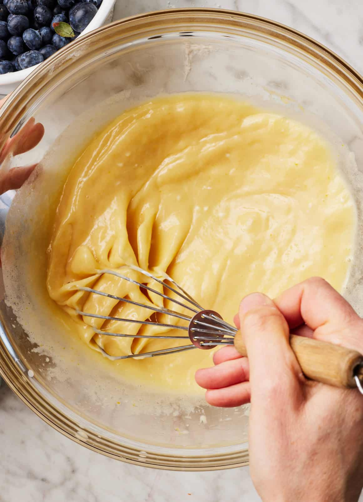 In a large bowl, whisk together the Greek yogurt, sugar, eggs, vegetable oil, milk, and vanilla until smooth.