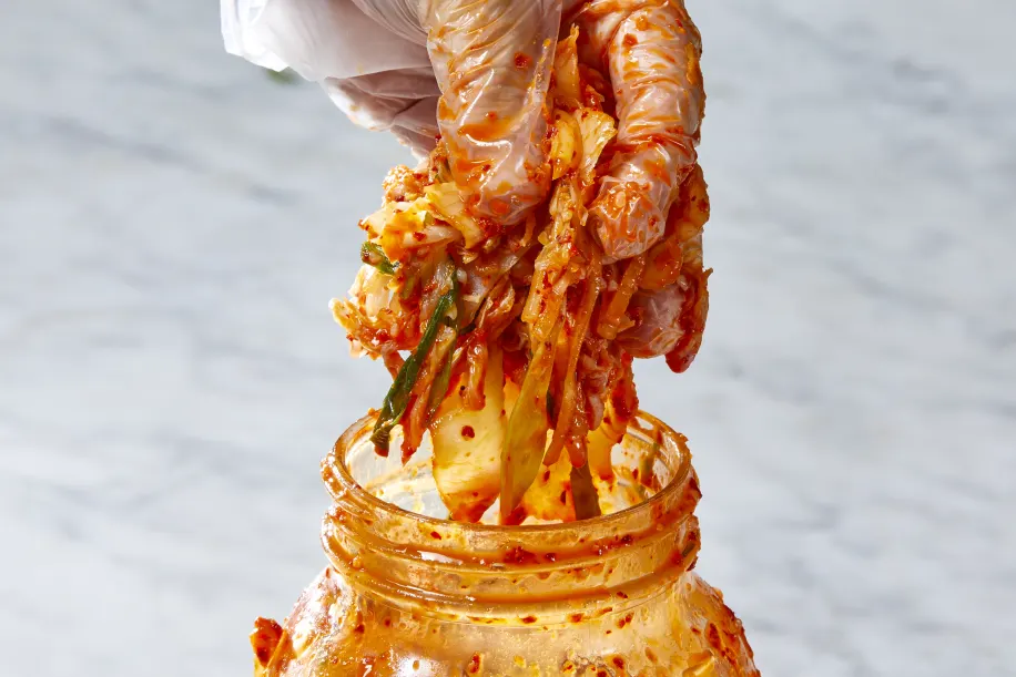 Pack the kimchi into a clean 1 quart jar. Press it down firmly until the liquid rises and covers the vegetables. Leave about 1 inch of space at the top, then seal the jar.