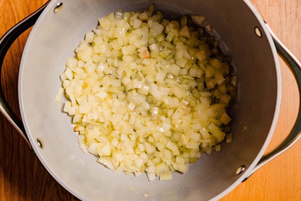 In a large pot or Dutch oven, heat the olive oil over medium-high heat until shimmering. Add the diced onion and ¾ teaspoon Morton kosher salt or 1 teaspoon Diamond Crystal kosher salt. Cook for about 3 minutes, stirring occasionally, until the onion starts to soften.