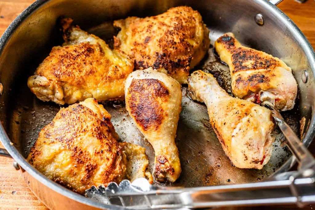 Heat a skillet over medium-high heat with oil, add the chicken in batches without crowding, and sear until browned on both sides before removing it from the pan.