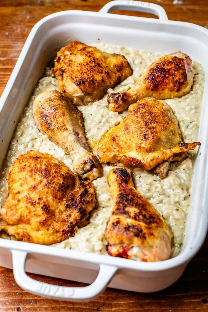 Place the seared chicken on top of the rice mixture, cover the dish tightly with foil, and bake until the rice begins to cook through.