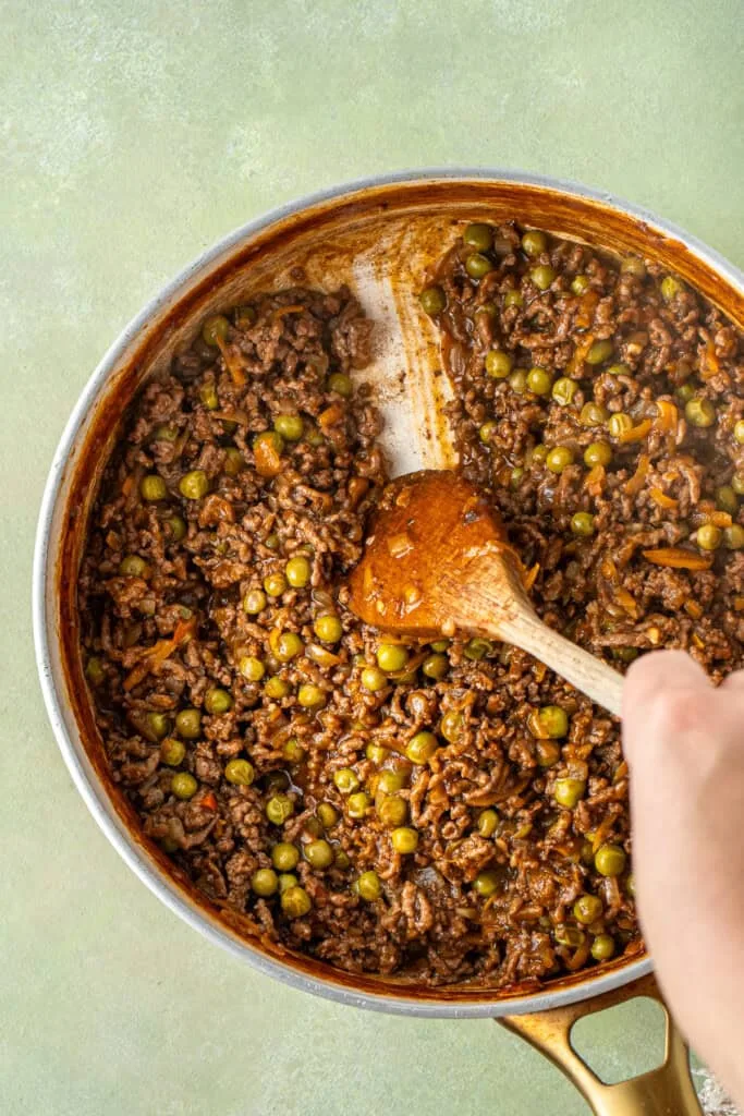 Stir in the peas and beef stock, season with salt and pepper, then bring to a boil before lowering the heat and simmering until the mixture thickens and holds its shape.