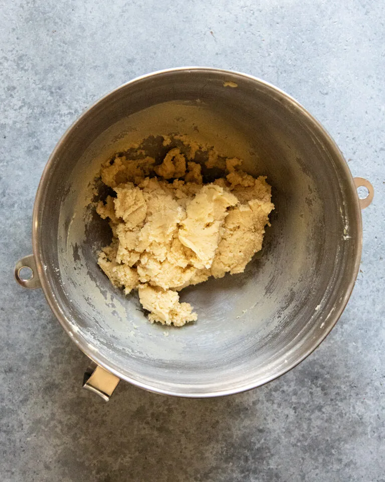 Add the flour, baking powder, baking soda, and salt, then mix gently until a soft dough forms, scraping the bowl as needed.