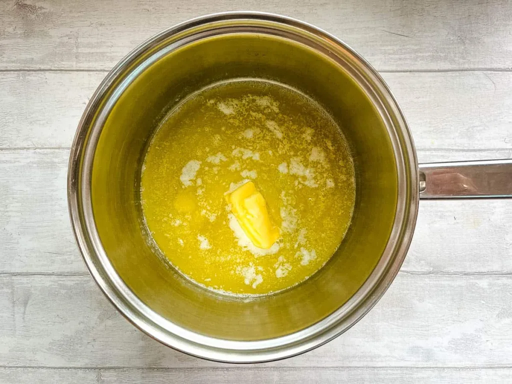 Preheat the oven to 180°C and gently melt the butter in a large pan over low heat until fully liquid.