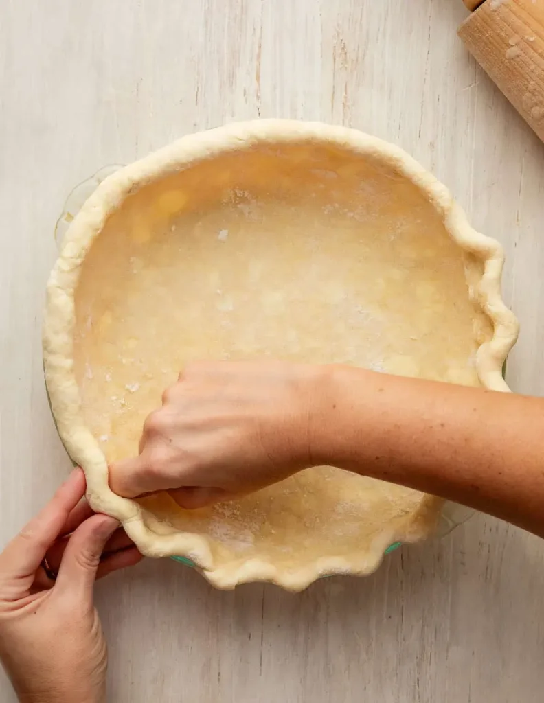 Turn the dough onto a floured surface, shape it into a disc, wrap it, and refrigerate until firm so it is easier to roll and holds its shape.