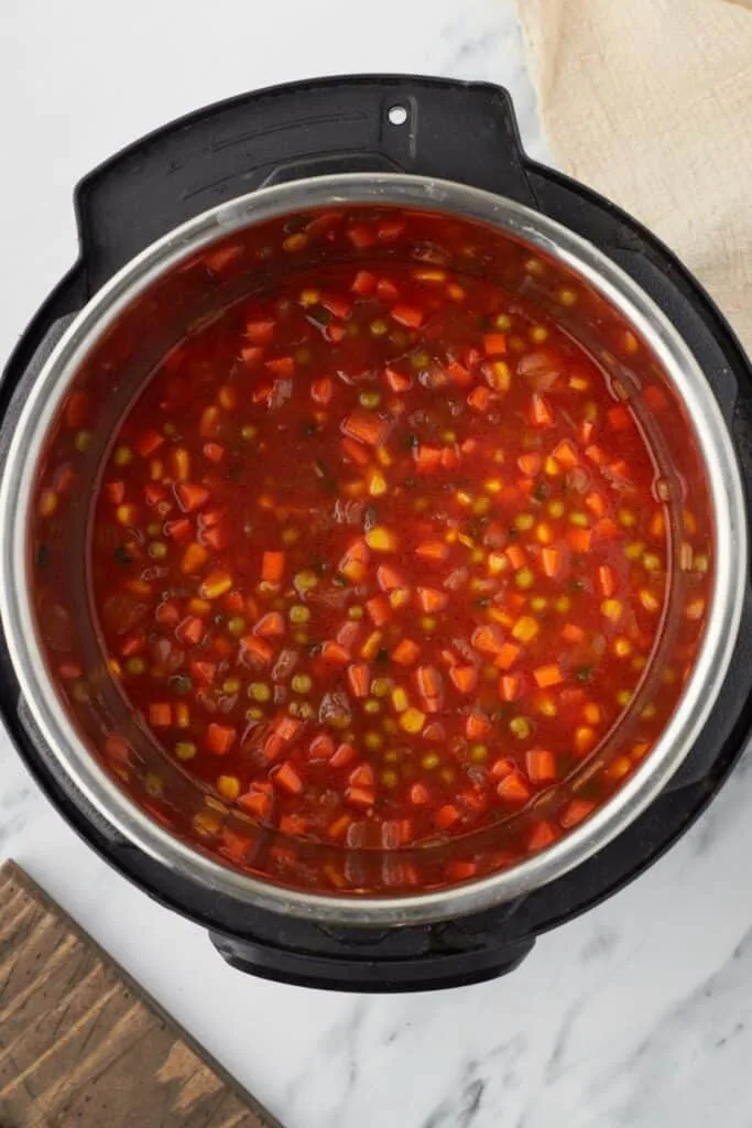 Stir in the tomato paste, chili powder, cumin, and salt, mixing continuously until the paste blends in and the spices become fragrant.