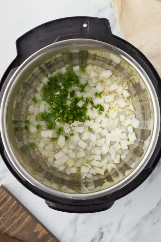 Add the garlic, jalapeno, and onion, stirring occasionally and cooking until the onion becomes soft and translucent.
