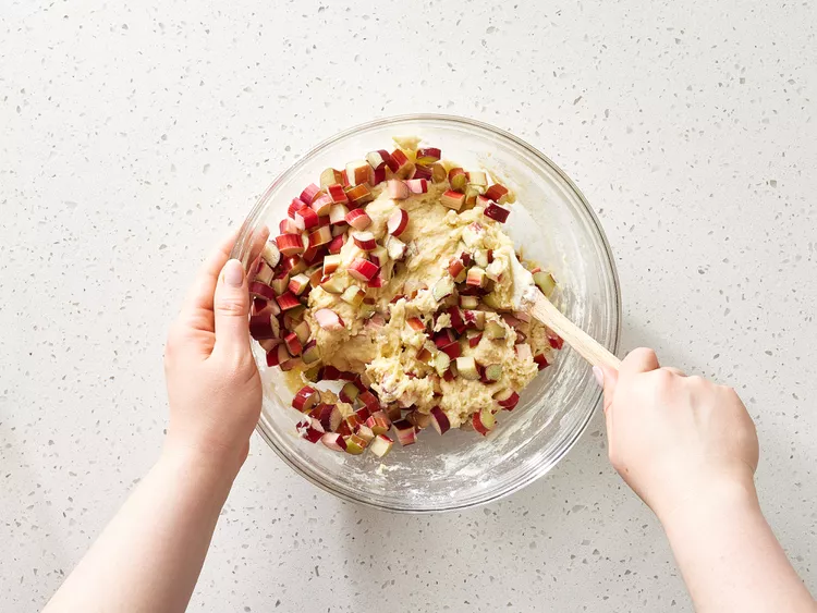 Add the beaten eggs and sour cream to the dry ingredients, stirring gently until the batter becomes smooth and well mixed.