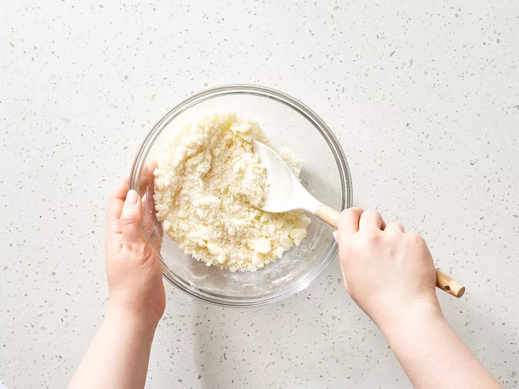 In a separate bowl, mix together the sugar and softened butter until smooth, then stir in the flour until the mixture becomes crumbly.