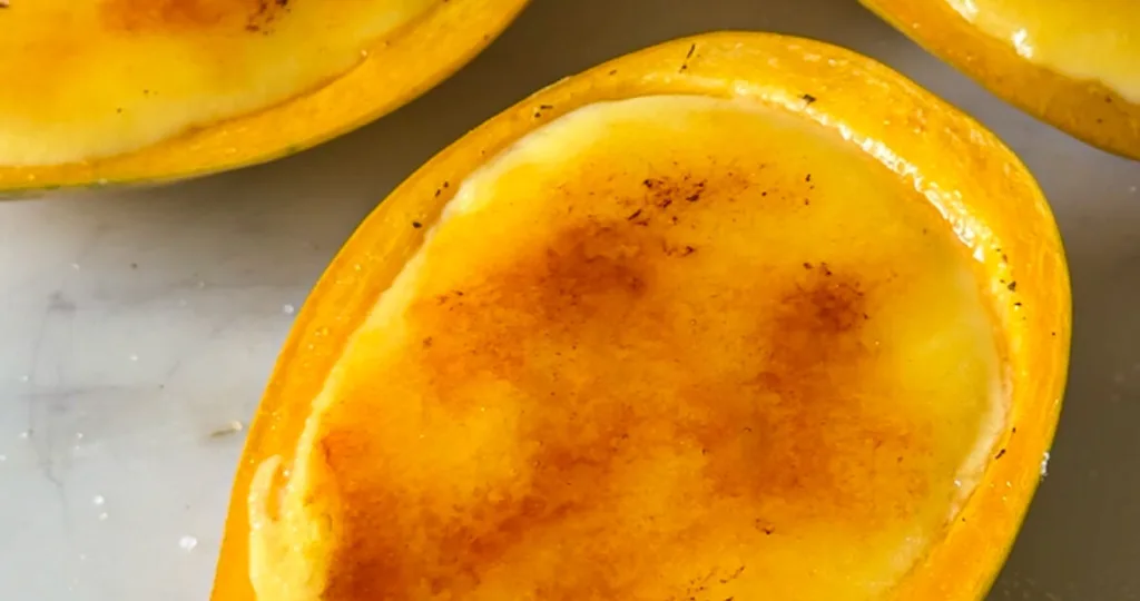 Slice the mangoes in half along the seed and carefully scoop out the flesh using a spoon, making sure the peels stay intact so they can be used as serving cups.