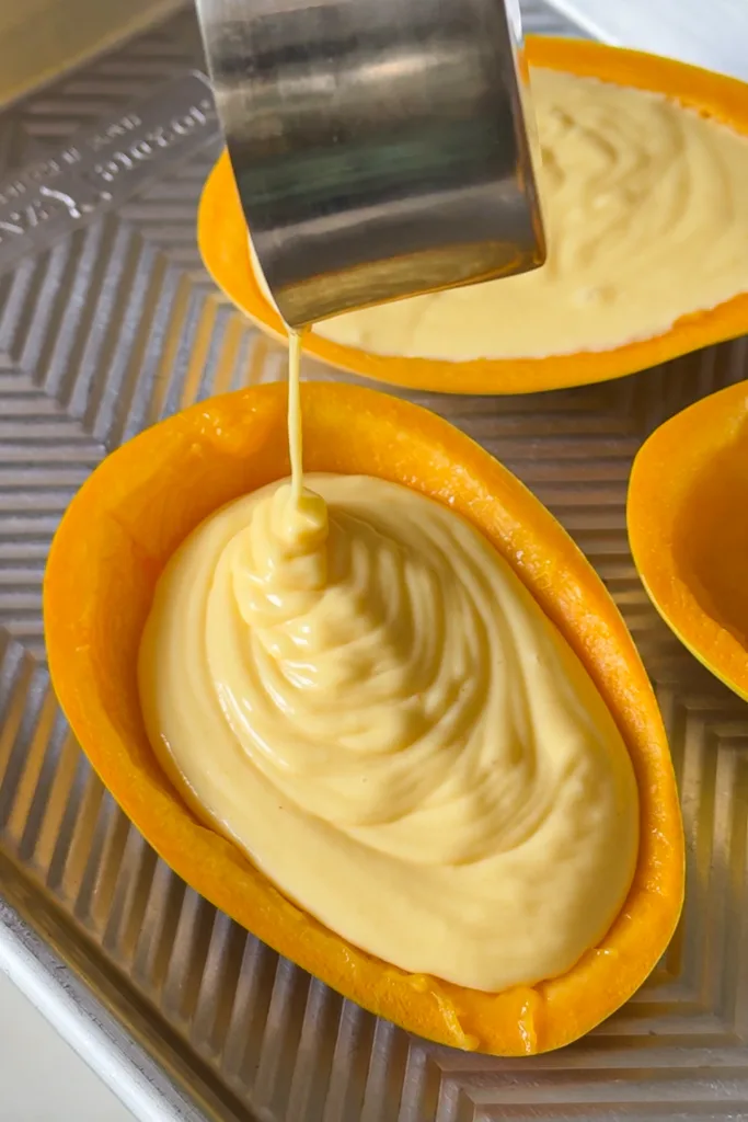 Place the filled mango cups in the refrigerator and chill for several hours or overnight until the dessert is fully set and firm.