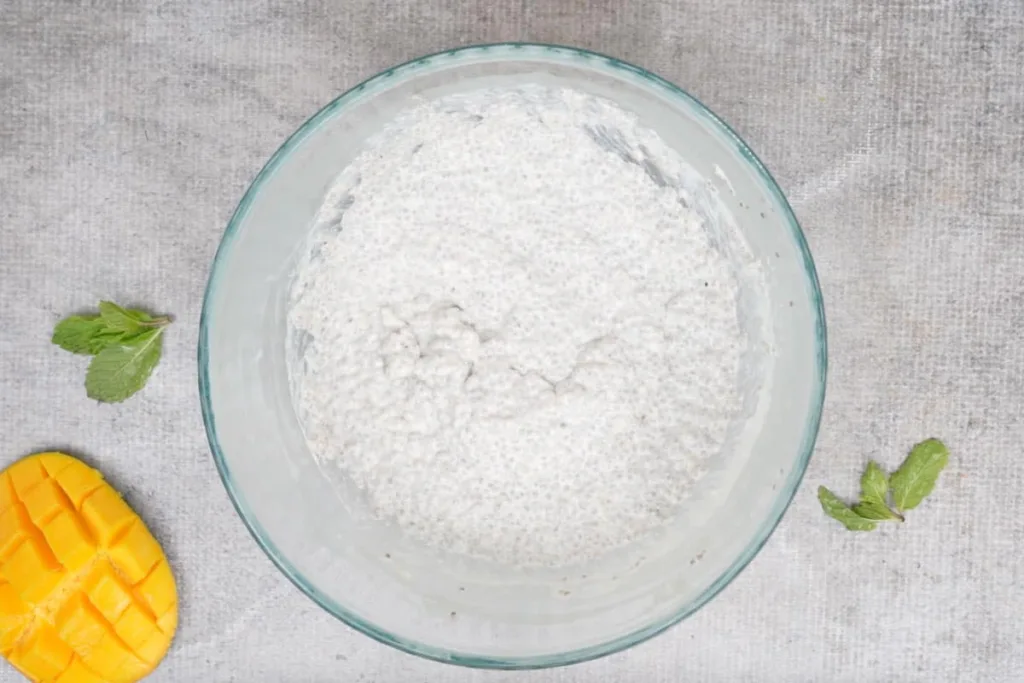 Remove the pudding from the refrigerator and mix well, adding a little extra coconut milk if needed to loosen it to a smooth and pourable texture.