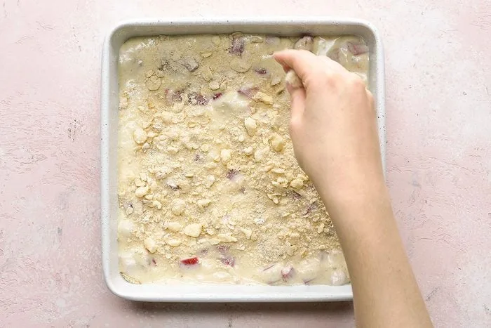 Spread the filling evenly over the prepared crust, making sure it reaches all corners of the pan.