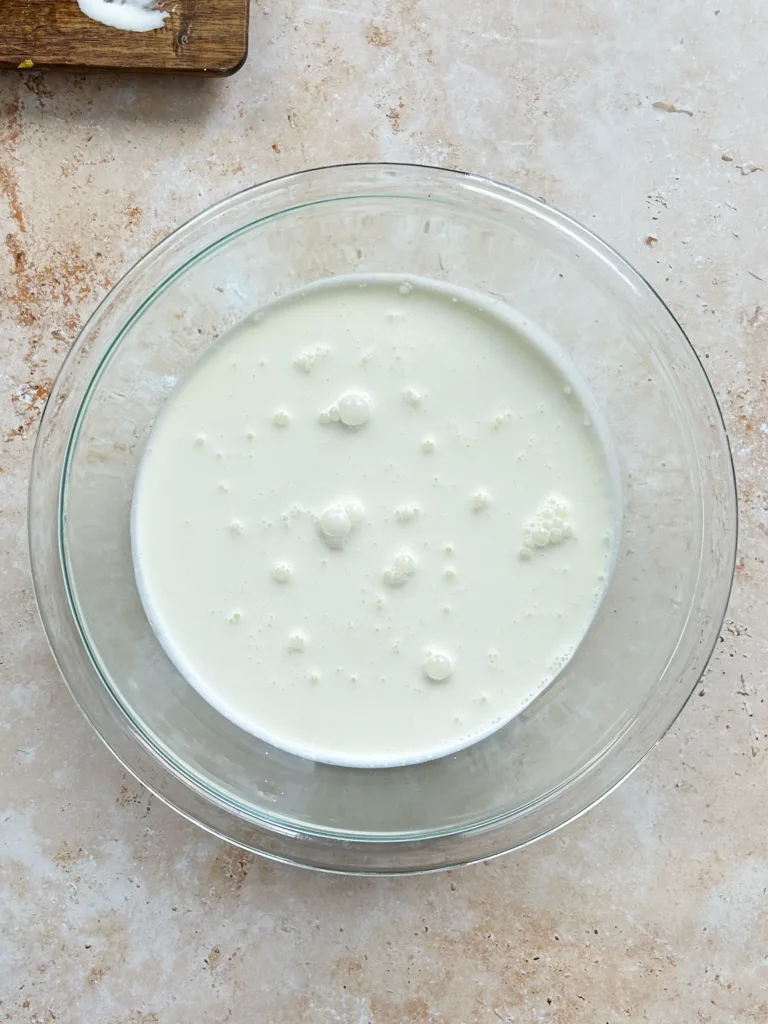 Add the chilled heavy cream to a large bowl and whisk on medium speed until it thickens to a soft, ribbony consistency without reaching stiff peaks.