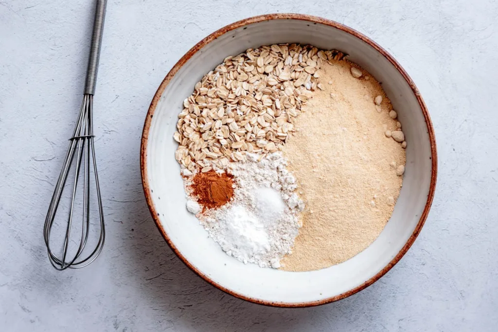 In another bowl, whisk together the granulated sugar, oat flour, sweet rice flour, oats, baking powder, cinnamon, and salt until well combined.
