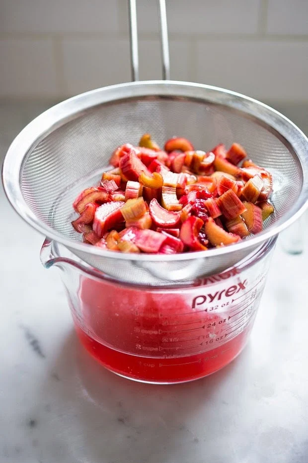 Strain the mixture through a fine mesh strainer, pressing firmly on the solids to extract as much syrup as possible.