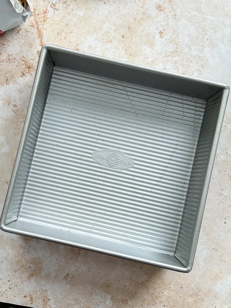 Prepare your pan by lining it with parchment paper if you plan to lift the dessert out later, or leave it unlined if serving directly from the pan.