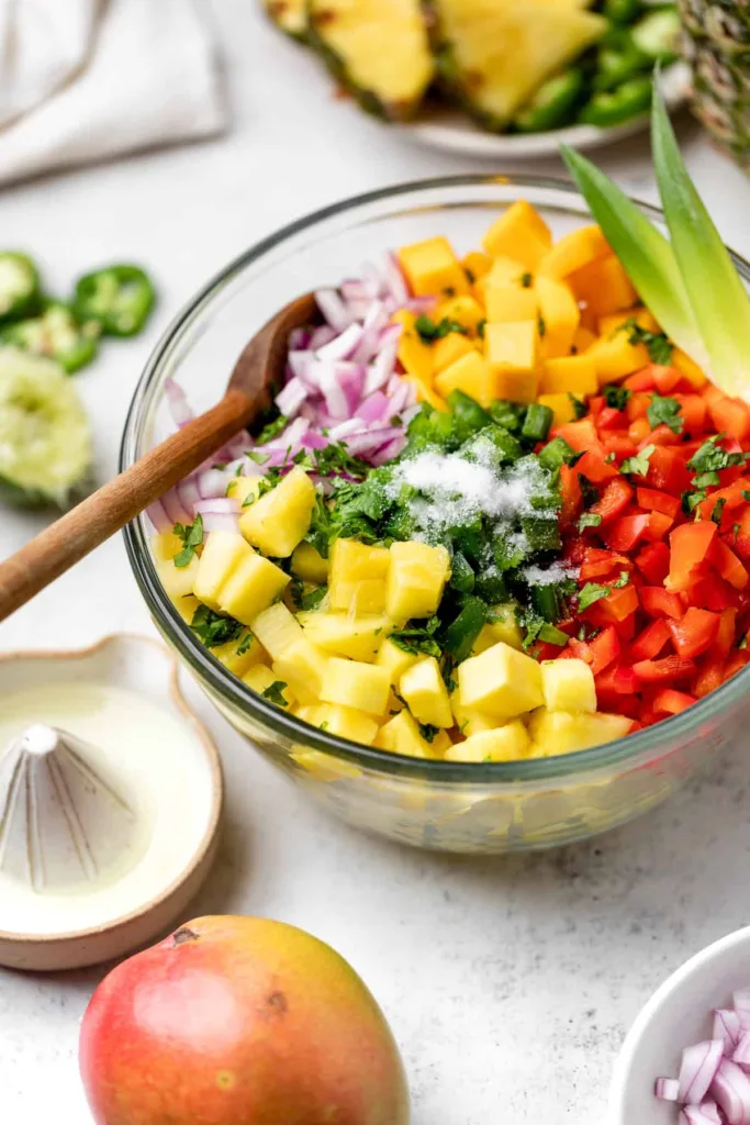 Pour the fresh lime juice over the mixture and sprinkle in the salt, ensuring the liquid and seasoning reach all the ingredients.