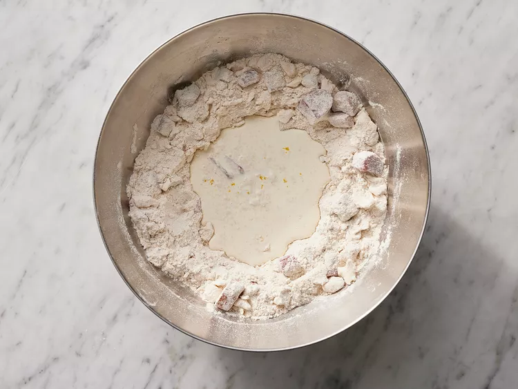 Whisk together the heavy cream, vanilla extract, and most of the orange zest in a separate container until smooth.