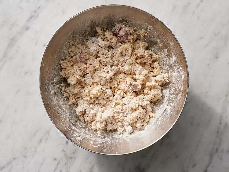 Create a well in the center of the dry ingredients and pour in the cream mixture, stirring gently just until the dough comes together without overmixing.
